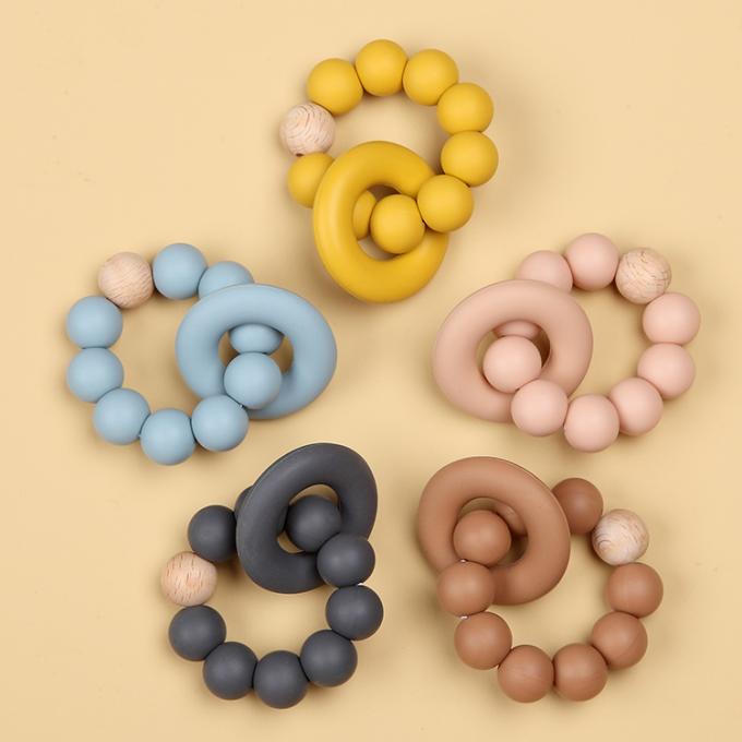 Juguete orgánico de goma natural al por mayor de Teether del bebé del silicón infantil con un anillo