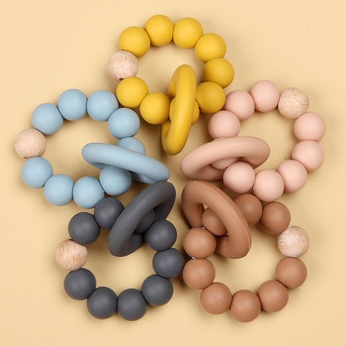 Juguete orgánico de goma natural al por mayor de Teether del bebé del silicón infantil con un anillo