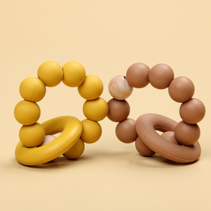 Juguete orgánico de goma natural al por mayor de Teether del bebé del silicón infantil con un anillo